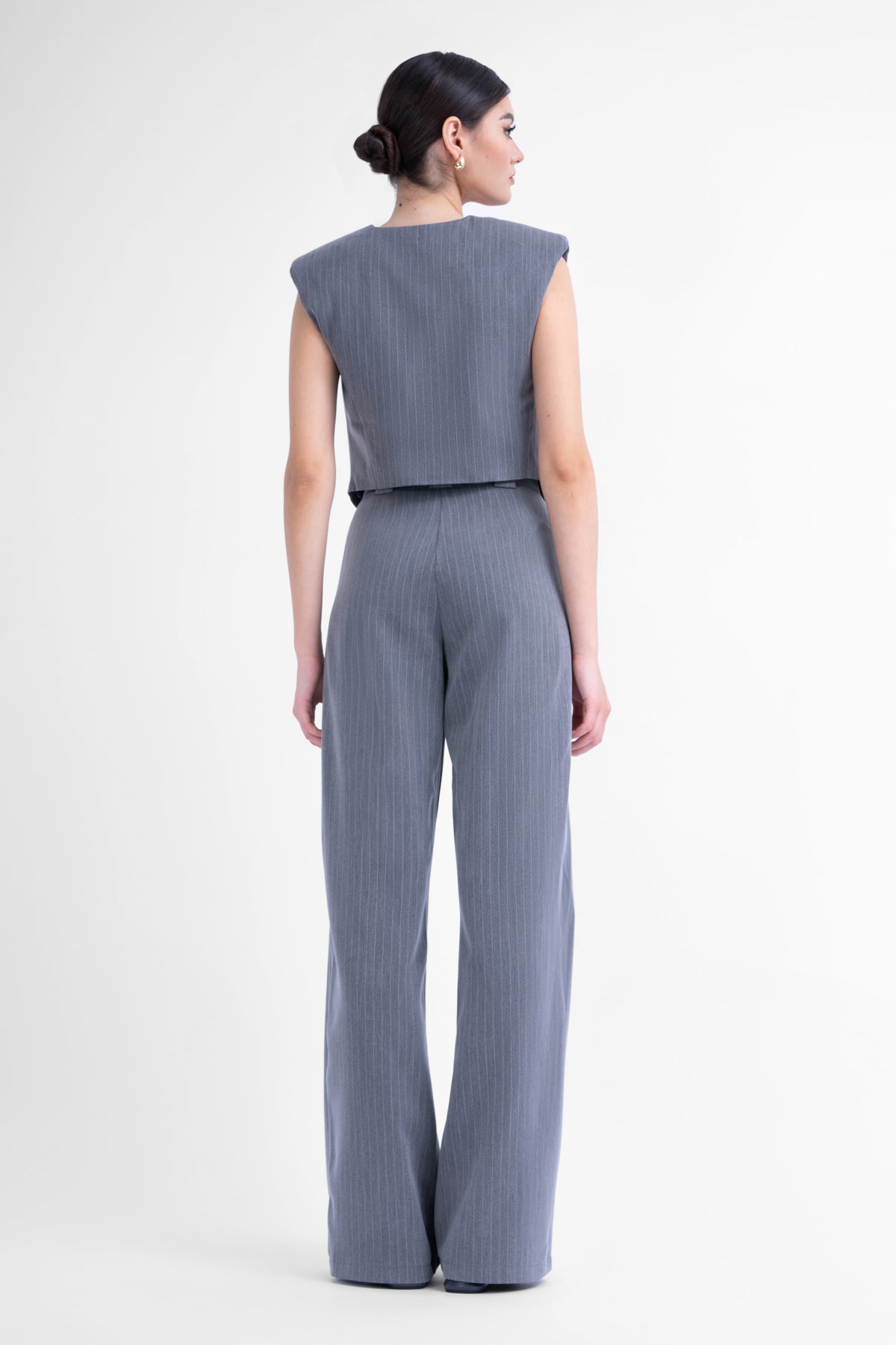 Grey pinstripe suit with asymmetrical vest and wide leg trousers