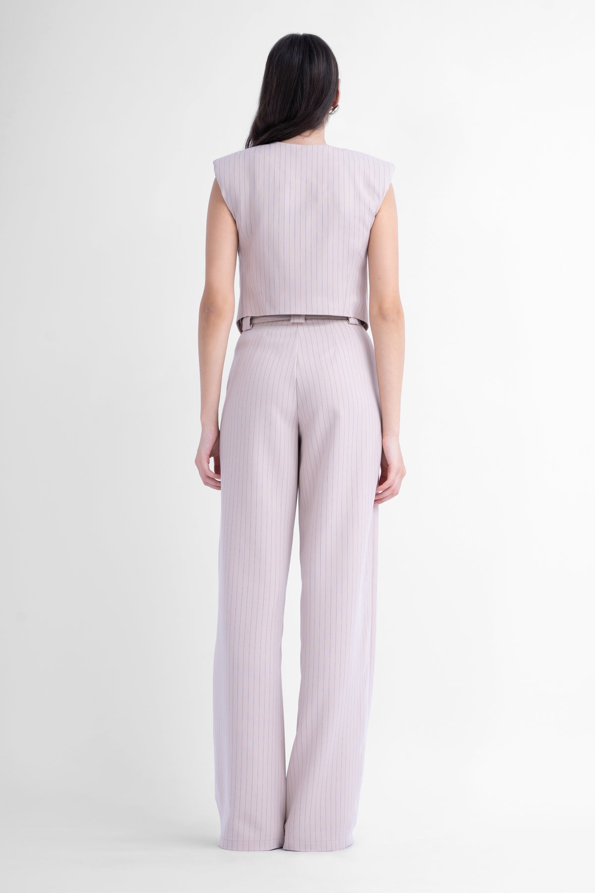 Beige pinstriped suit with asymmetrical vest and wide leg trousers