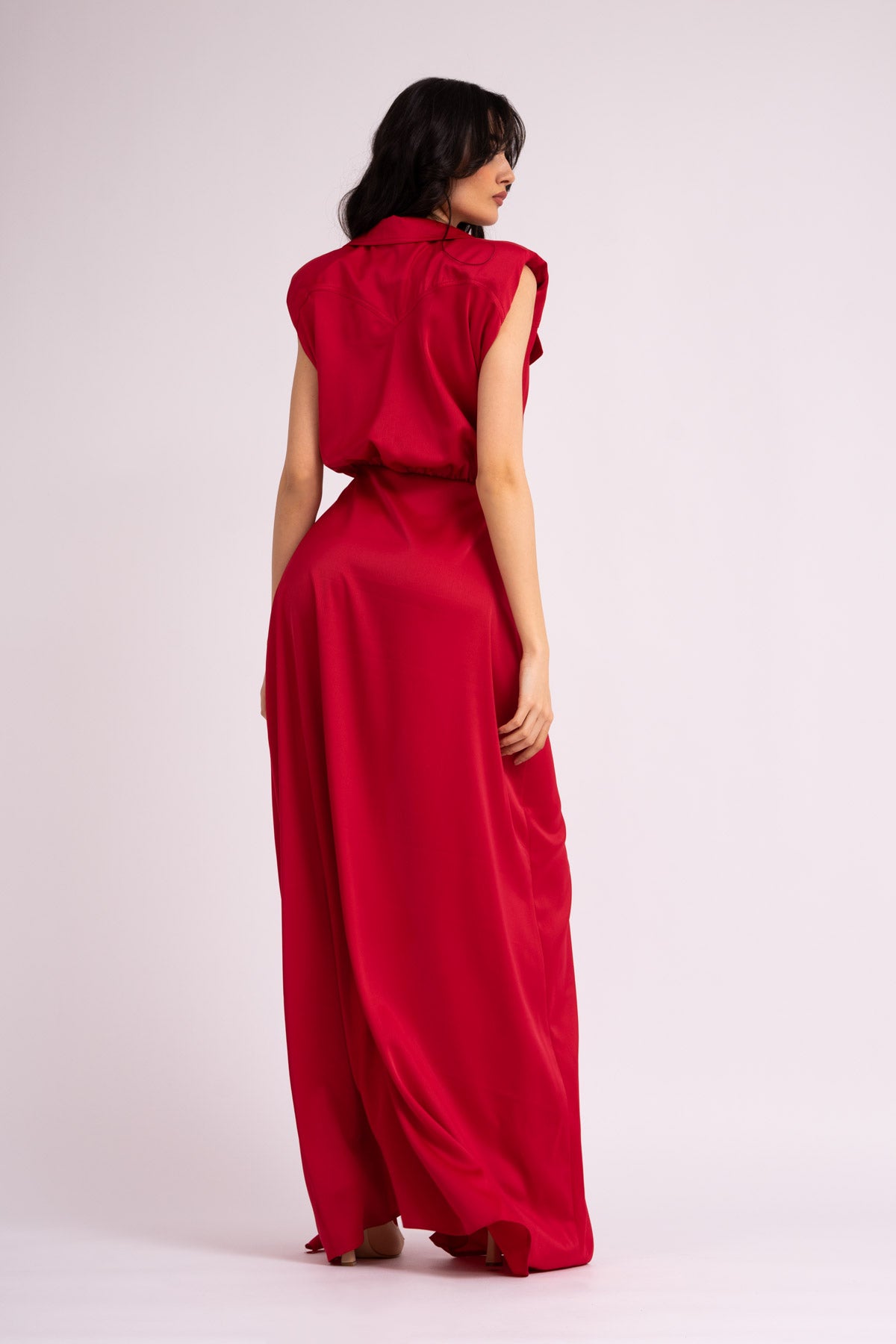 Red maxi dress with oversized shoulders and ruffled slit