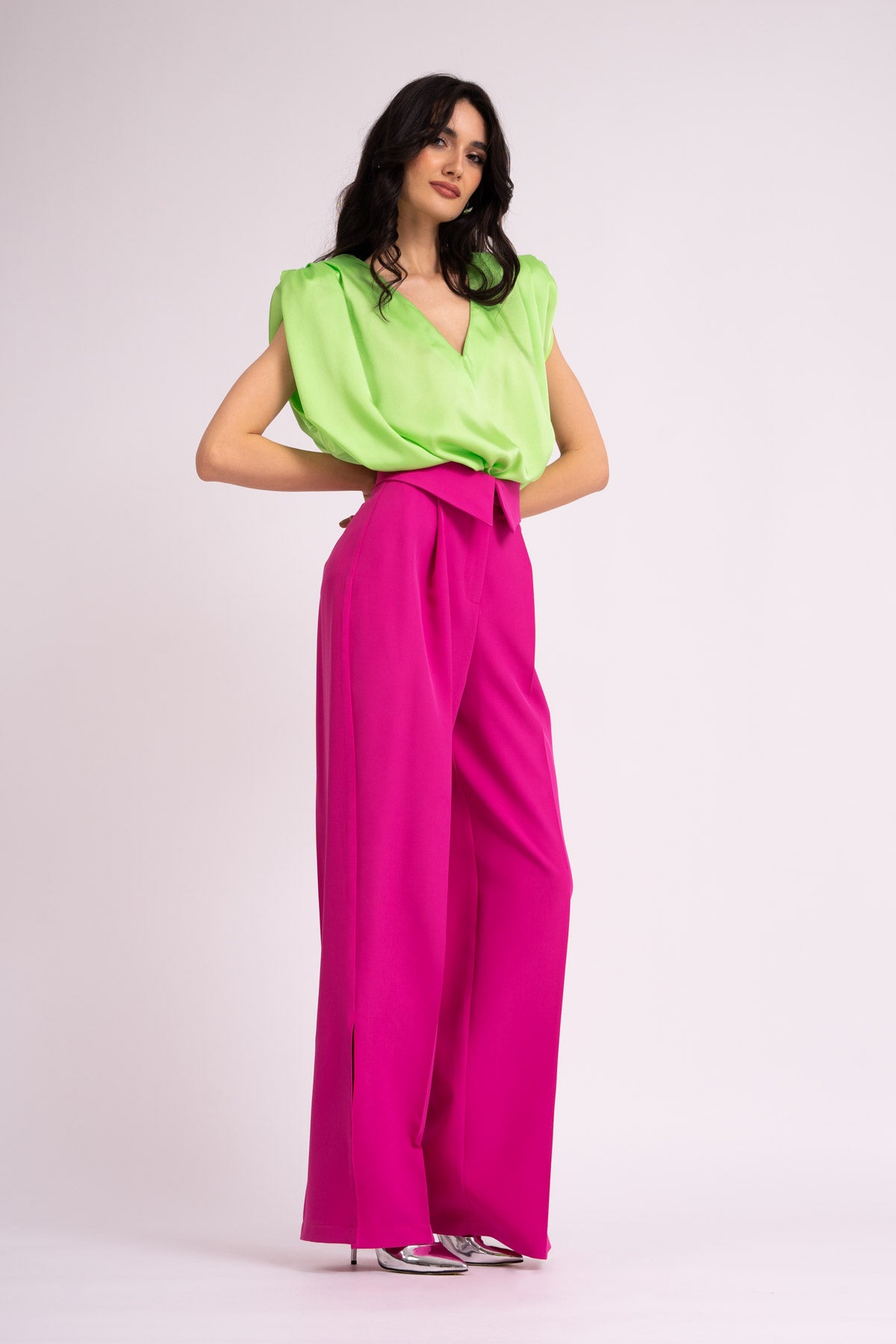 Neon green draped top with padded shoulders and 'V' neckline