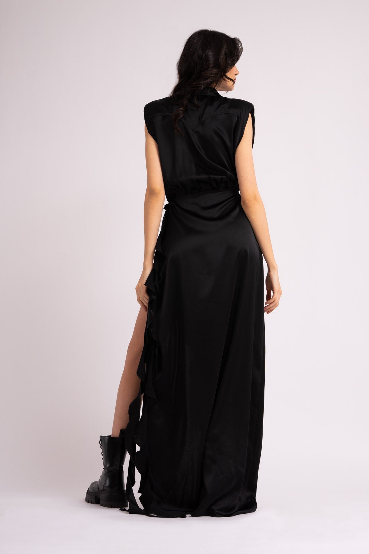 Black maxi dress with oversized shoulders and ruffled slit
