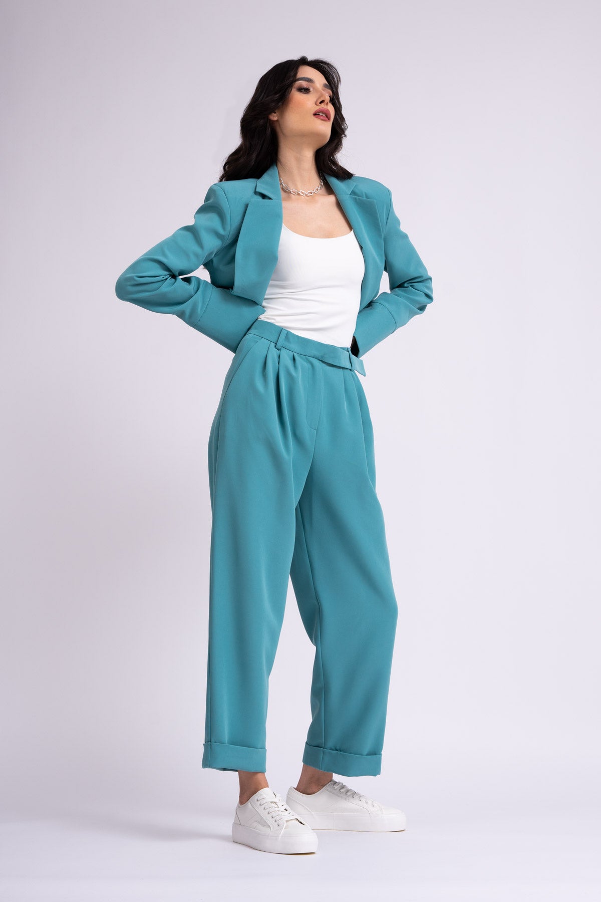 Turquoise suit with cropped blazer and trousers