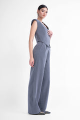 Grey pinstripe suit with asymmetrical vest and wide leg trousers