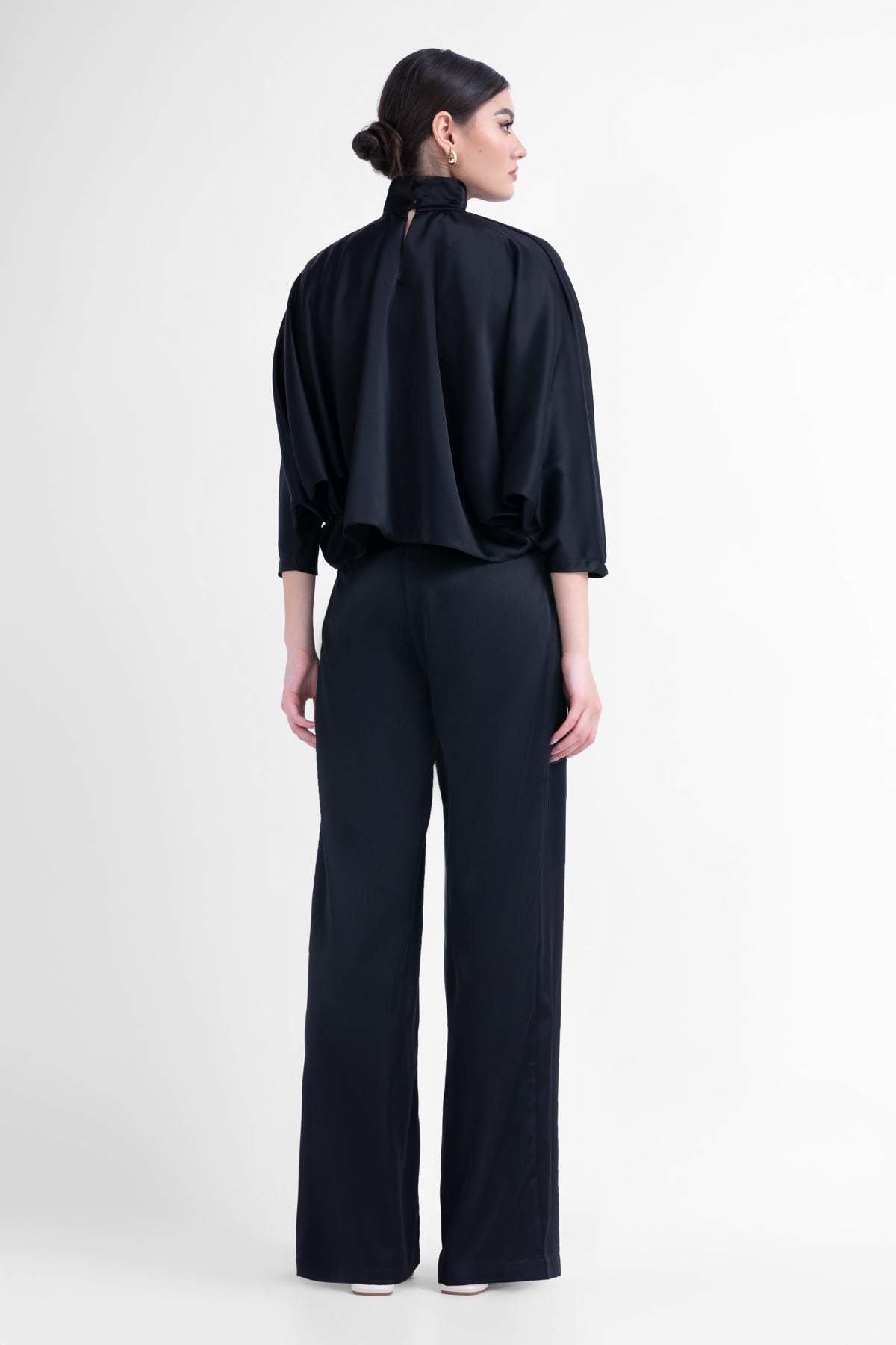Black asymmetrical wide leg trousers with button