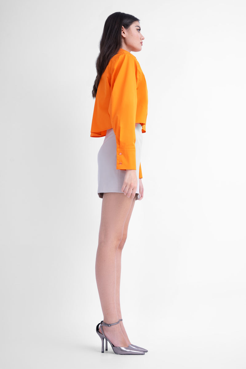 Bright orange cropped poplin shirt with oversized shoulders