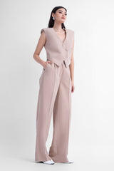 Beige suit with asymmetrical vest and wide leg trousers