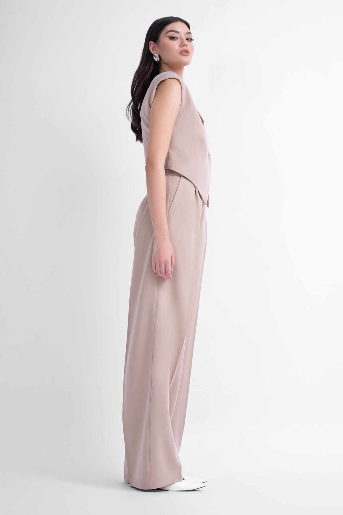 Beige suit with asymmetrical vest and wide leg trousers