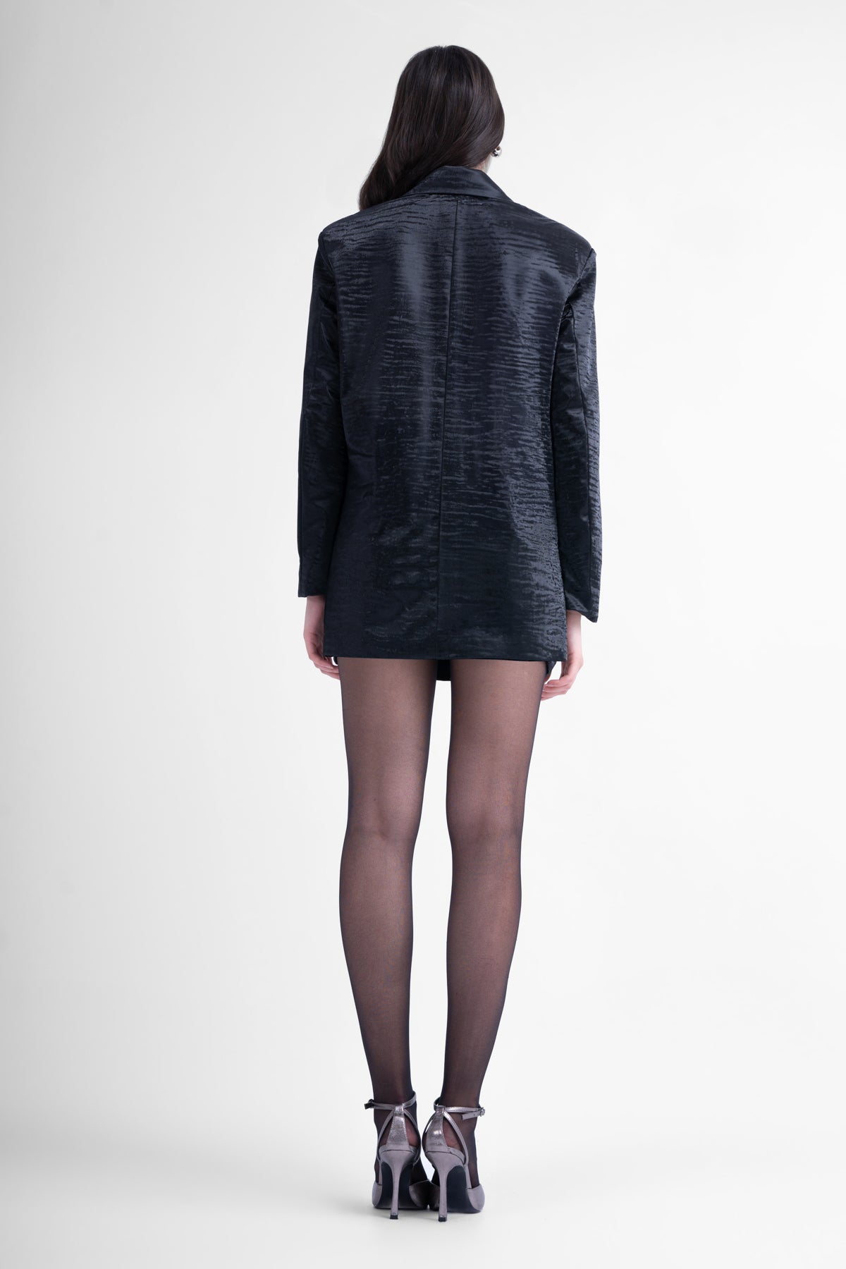 Printed black leather suit with regular blazer and mini skirt