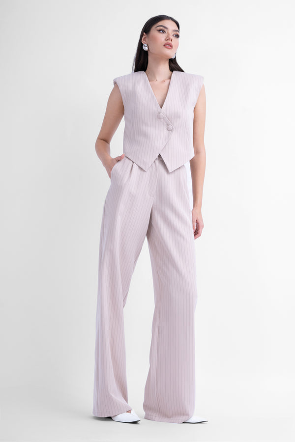 Beige pinstriped suit with asymmetrical vest and wide leg trousers