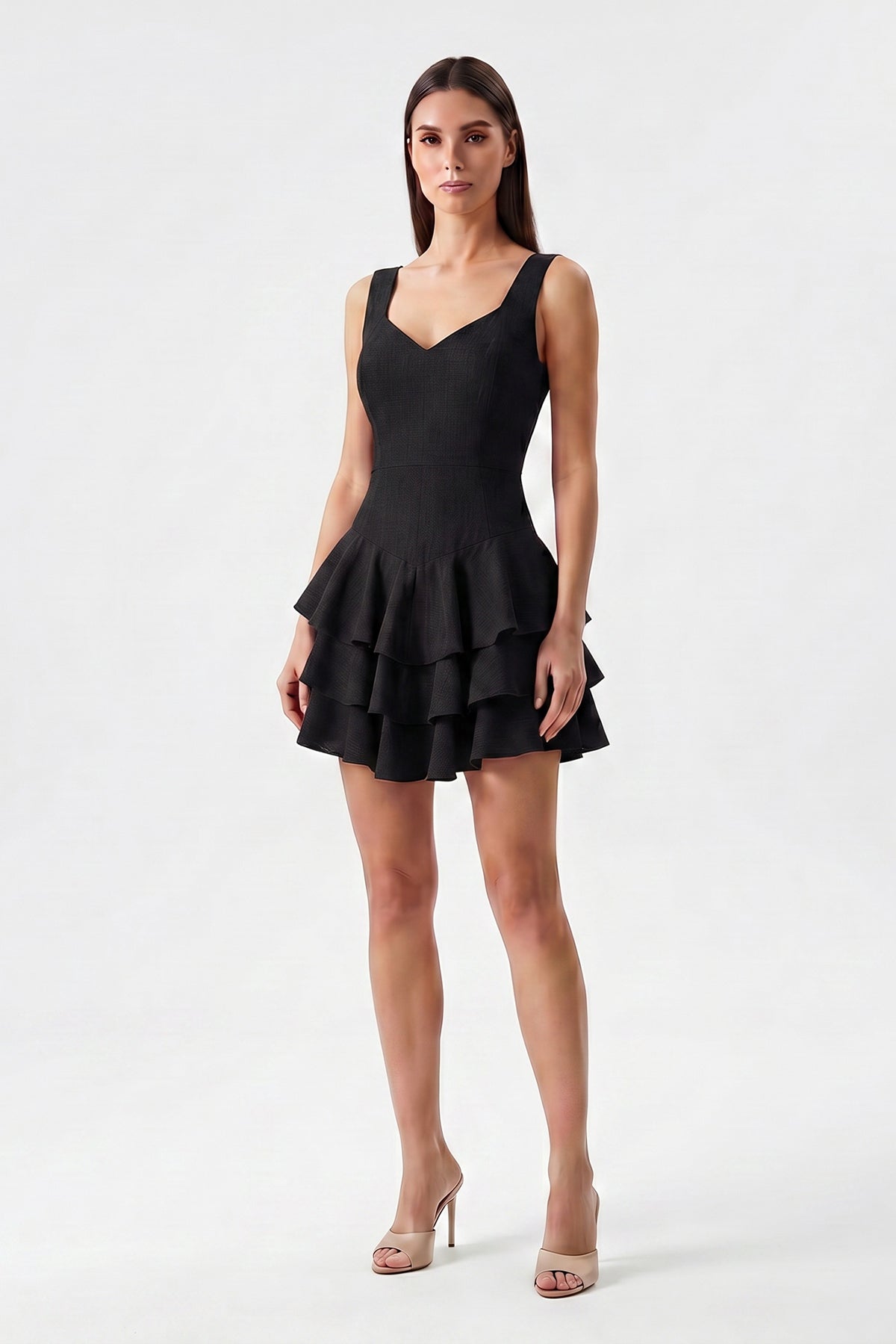 Black linen mini dress with fitted silhouette and layered ruffle skirt