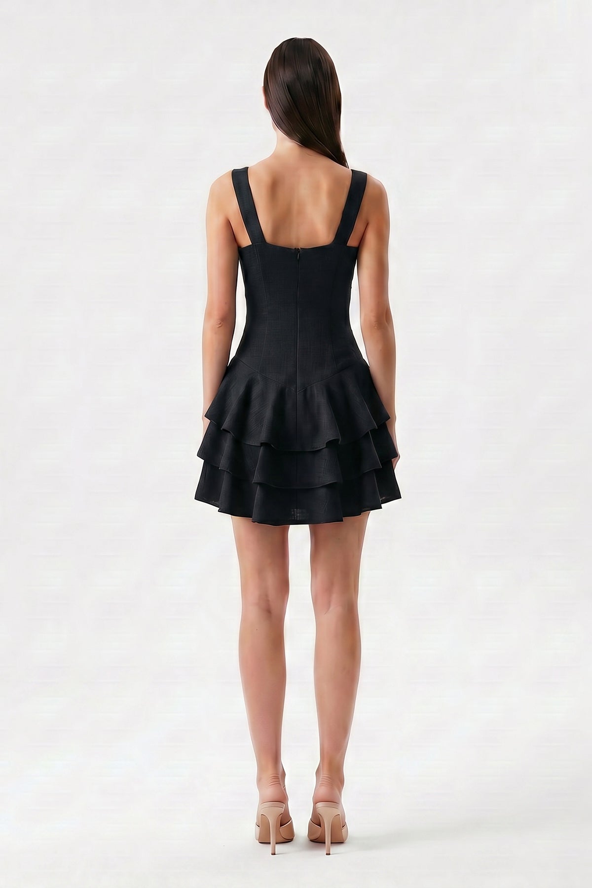 Black linen mini dress with fitted silhouette and layered ruffle skirt