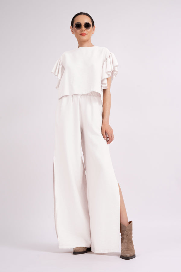 White set with ruffled T-shirt and trousers with slits