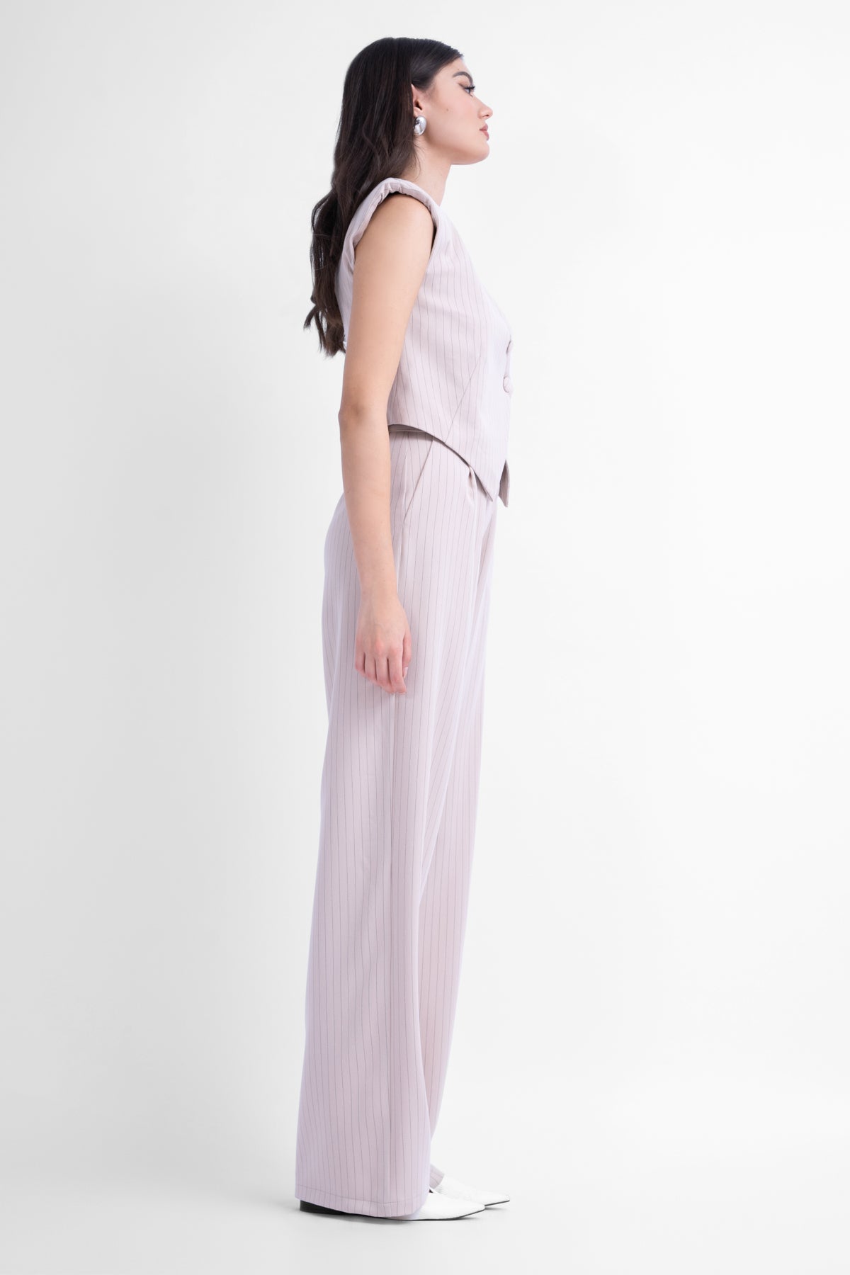 Beige pinstriped suit with asymmetrical vest and wide leg trousers