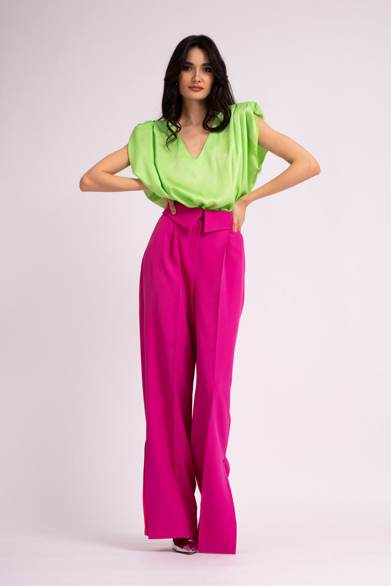 Neon green draped top with padded shoulders and 'V' neckline