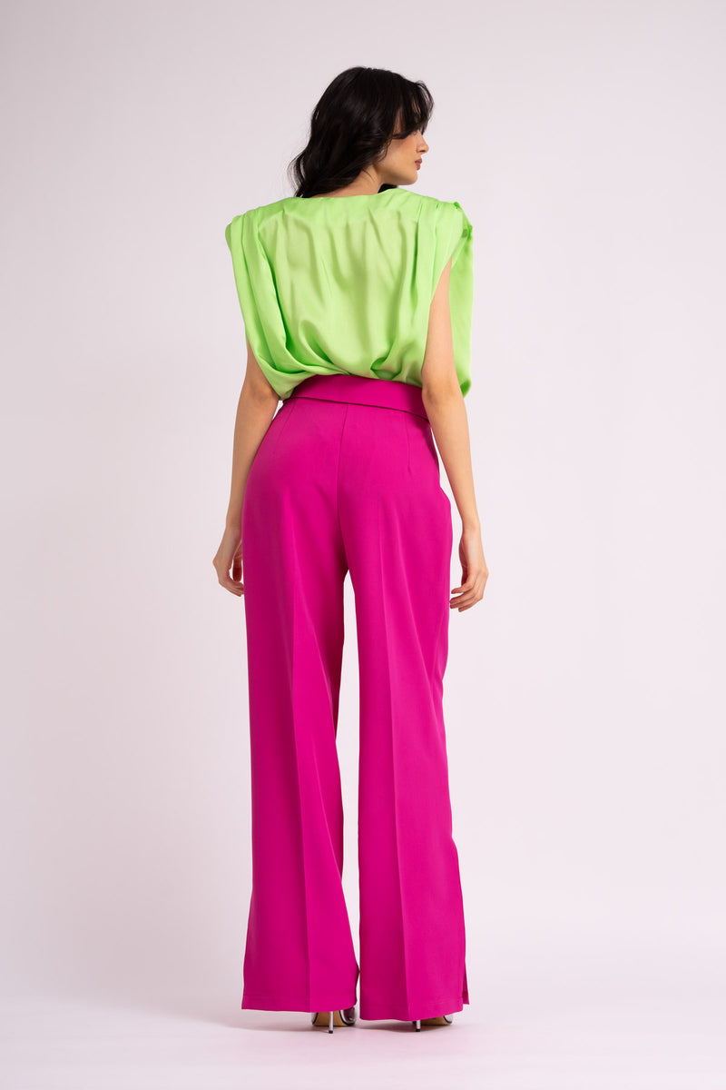 Neon green draped top with padded shoulders and 'V' neckline