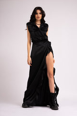 Black maxi dress with oversized shoulders and ruffled slit