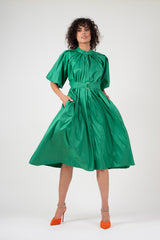 Green dress with raglan sleeve and pleats