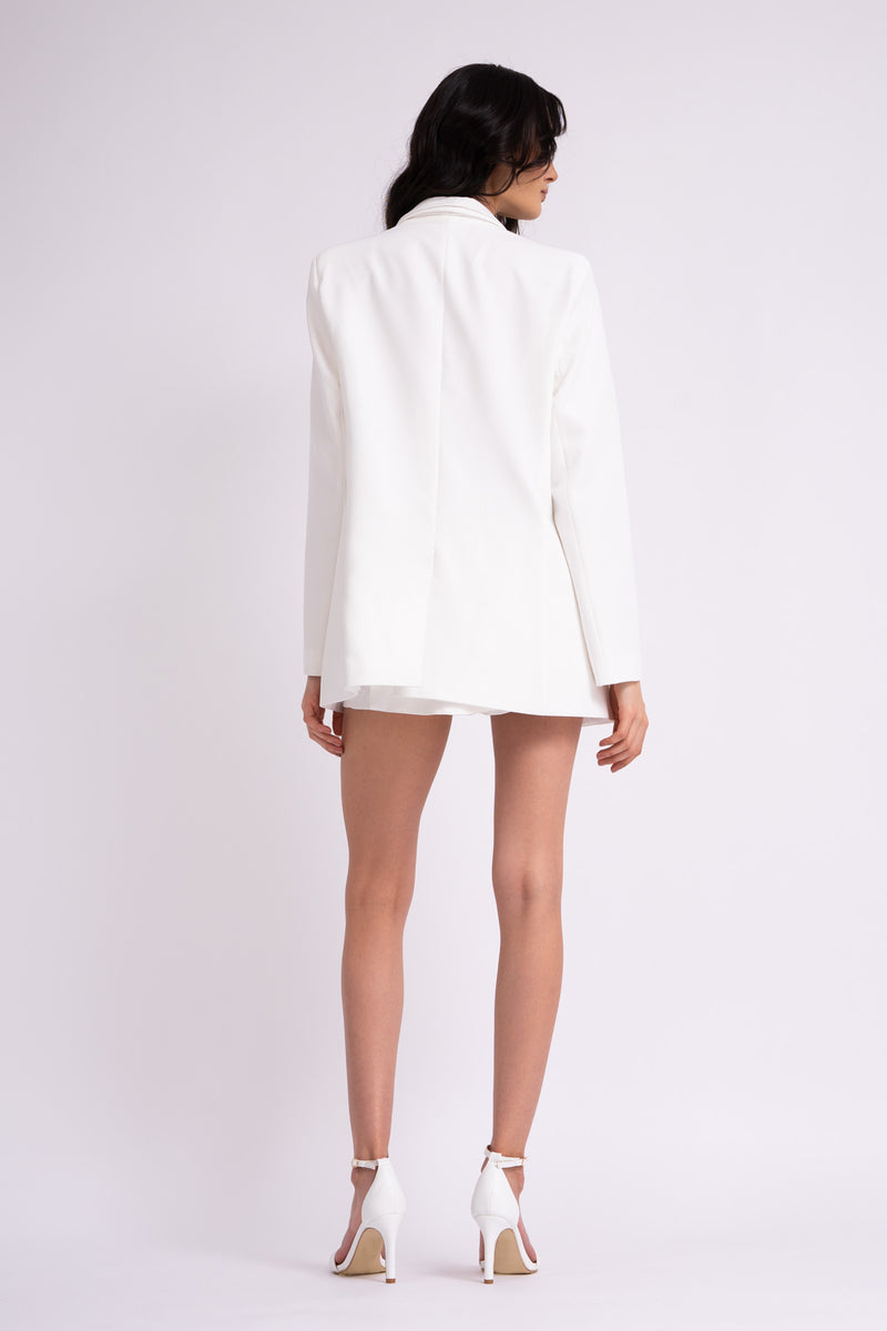 White suit with oversized blazer with double lapels and shorts with skirt