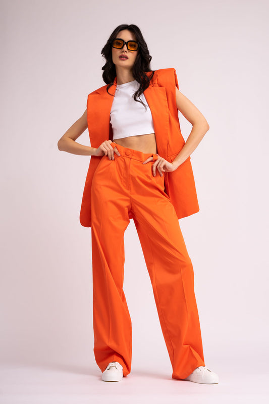 Neon orange suit with oversized vest and wide leg trousers