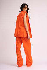 Neon orange suit with oversized vest and wide leg trousers